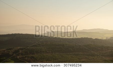 Landscape View From Gummers How In Lake District Over Beautiful Autumn Fall Color Forest With Hazy U