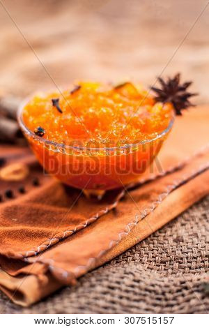 Famous Indian Dessert And Sweet Dish In A Glass Bowl On Jute Bag's Surface I.e. Murabba Or Murba Alo