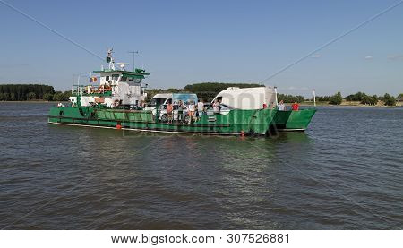 Tulcea, Romania - August 8th, 2018: A Ferry Boat Transporting People And Vehicles Across The Danube 