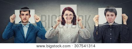 Tree People Covering Their Faces Using Photo Sheets With Happy, Sad And Neutral Emotions, Like Mask 
