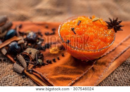 Famous Indian Dessert And Sweet Dish In A Glass Bowl On Jute Bag's Surface I.e. Murabba Or Murba Alo