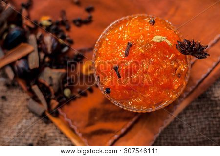 Famous Indian Dessert And Sweet Dish In A Glass Bowl On Jute Bag's Surface I.e. Murabba Or Murba Alo