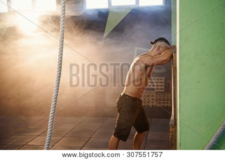 Tired Sport Man Resting After Hard Exercise In The Gym.