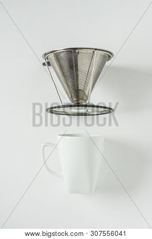 White Coffee Mug On White Background With Filterless Metal Pour Over Drip Cone