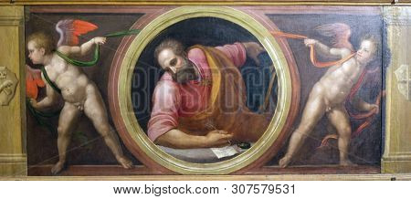 FLORENCE, ITALY - JANUARY 10, 2019: Saint Matthew and Two Angels supporting a curtain, altar from Morelli Chapel in the Basilica di Santa Croce (Basilica of the Holy Cross) in Florence, Italy