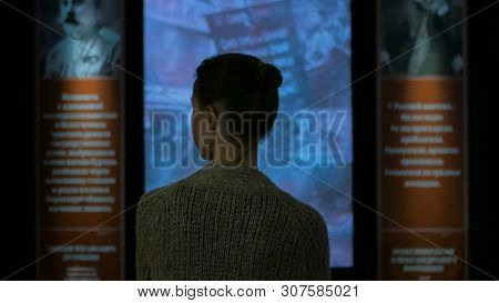 Young Woman Looking Around In Modern Historical Museum. Evening Time, Lowlight. Education And Entert