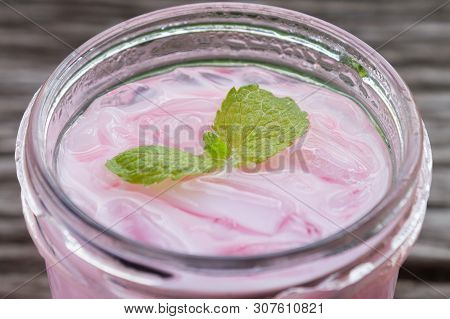 Pink Cold Milk Beverage Or Cold Drinks And Peppermint Zoom View. Pink Cold Drinks And Ice On Wood Ta