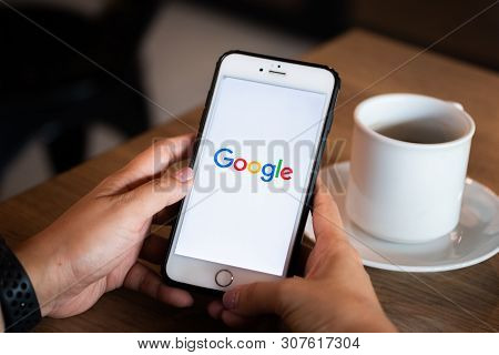 Chiang Mai / Thailand - June 22 2019 : Hands Hoding Mobile With Google Screen In Coffee Shop.