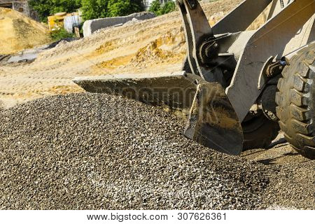 Tractor Collects Scoop With  Gravel. Excavator Extracts Sand And Gravel For  Concrete Mix.