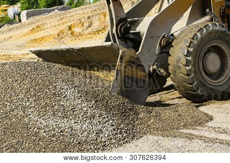 Tractor Collects Scoop With  Gravel. Excavator Extracts Sand And Gravel For  Concrete Mix.