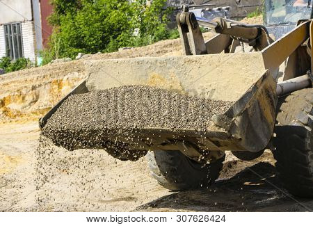 Tractor Collects Scoop With  Gravel. Excavator Extracts Sand And Gravel For  Concrete Mix.