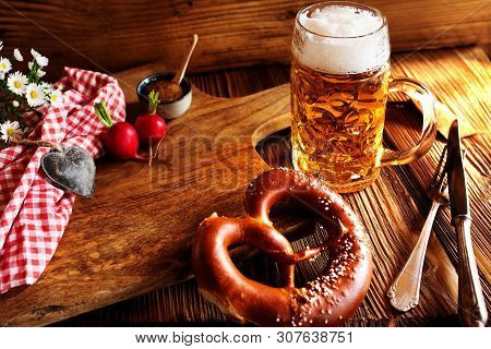 Bavarian Specialties With Fresh Beer And Salt Pretzel On Rustic Wood