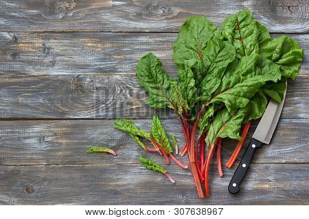 Fresh Raw Leaves Of Chard, Leaf Beets, Mangold, Swiss Chard On A Wooden Table, Close Up, Free Space