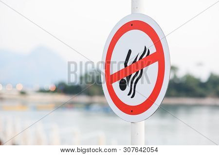 No Swim Prohibition Sign Near The Water On Sea Beach. The Area Has Dangerously Strong Currents And U