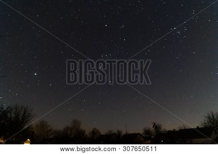 A Lond Exposure Low Light Photo Of Village And  Night Sky. Village Far Away From City, On Sky A Lot