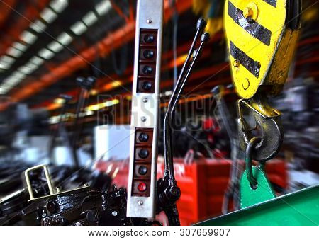 Crane Hook Of The Overhead Crane In The Workshop Of An Industrial Plant For The Production Of Tracto