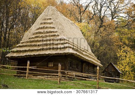 Old Village House With Thatched Roof. Traditional Ukrainian Architecture