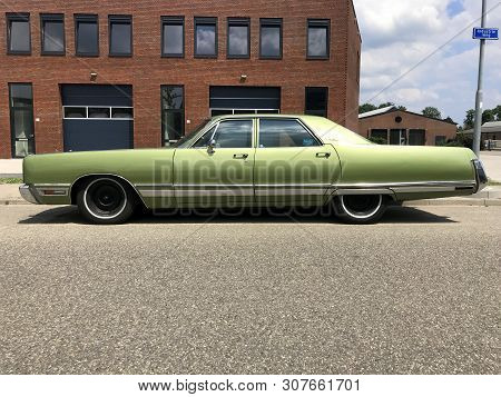 Woerden, The Netherlands - June 22, 2019: Green Chrysler New Yorker Parked By The Side Of The Road. 