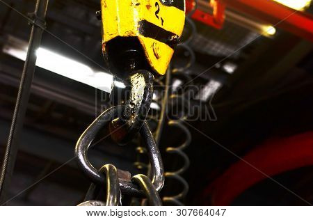 Crane Hook Of The Overhead Crane In The Workshop Of An Industrial Plant For The Production Of Tracto