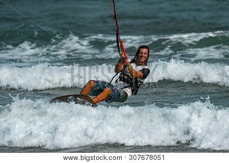 Kitesurfing on the waves of the sea in Mui Ne beach, Phan Thiet, Binh Thuan, Vietnam. Kitesurfing, Kiteboarding action photos Kitesurfer In action