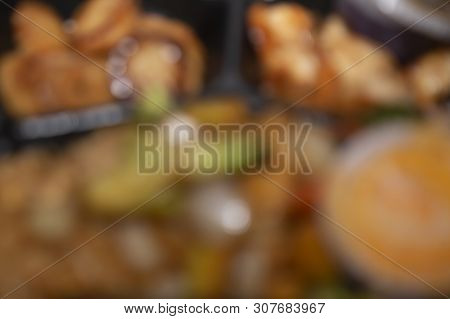 Blurred Scallops, Shrimp, Rice, Veggies And Sauce Takeout In A Carryout Container