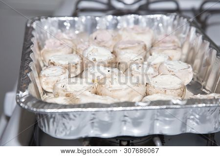 Mushroom Caps Stuffed With Chive Cream Cheese On A Foil Container