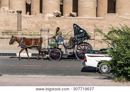 Luxor Egypt 23.05.2018 Tourist Caleche Horse Carriage Outside Luxor Temple In Background