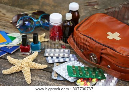 Summer Women's Beach Accessories For Your Sea Holiday And First Aid Kit On Old Wooden Background. Co