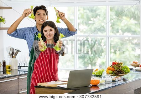 Couple In Apron Make Salad Rolls Together..