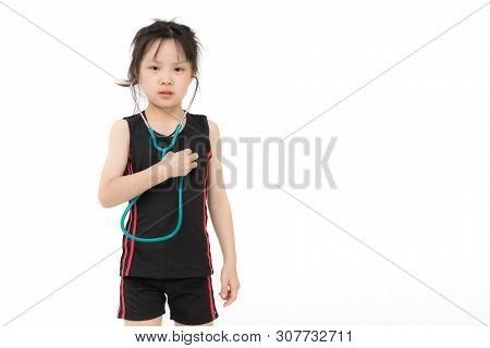 Pretty Asian Girl In Sportswear Wears Green Stechoscope And Posing To Camera, Studio Shot On White B