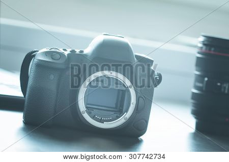 Professional Camera: Reflex Camera With Open Sensor. Lenses In The Background.