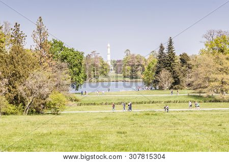 Lednice, Czech Republic - April 22, 2019:tourist In Park Next To Castle Lednice On April 22,2019 In 