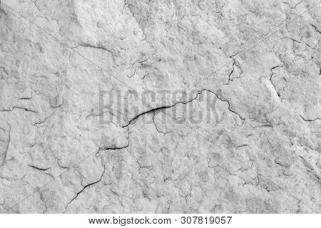 The Texture Of Natural Stone Granite With Small Cracks. Background Of Natural Stone Gray. Texture Wi