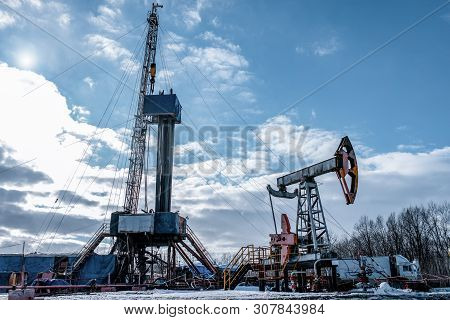 Drilling Rig In Oil Field For Drilled Into Subsurface In Order To Produced Crude. Petroleum Industry