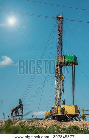 Drilling Rig In Oil Field For Drilled Into Subsurface In Order To Produced Crude. Petroleum Industry