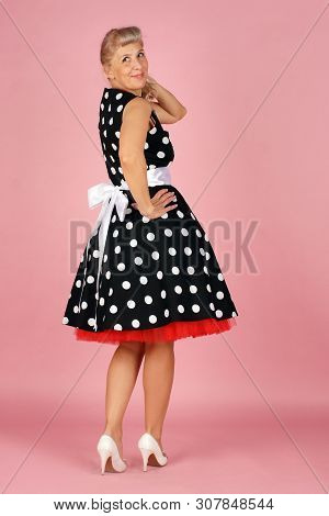 Beautiful Blonde Woman In A Polka-dot Dress, Coyly Turned Around Over Her Shoulder And Smiling, Pin-