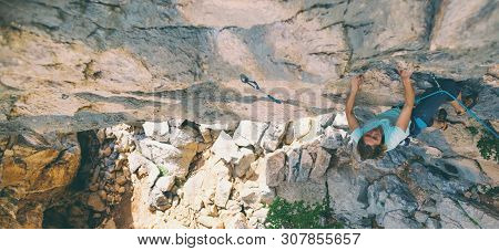 Rock Climbing And Mountaineering In The Paklenica National Park. A Woman Overcomes A Challenging Cli