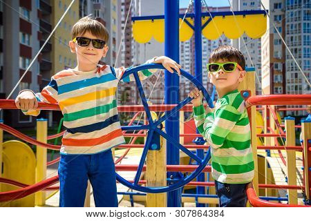 Two Brothers Sibling Boy As A Captain Or Sailors Play On The Ship Outdoors On Sunny Day. Kids Has A