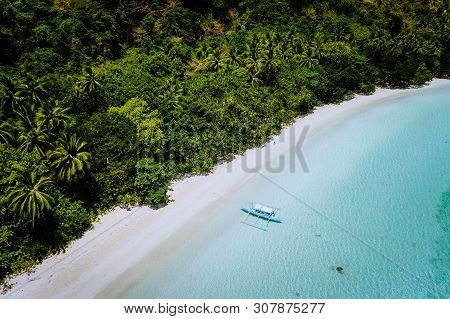 Aerial Drone View Of A Beautiful Secluded Deserted Tropical Beach. Lonely Boat In Turquoise Lagoon I