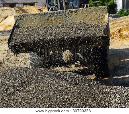 Tractor Collects Scoop With  Gravel. Excavator Extracts Sand And Gravel For  Concrete Mix.