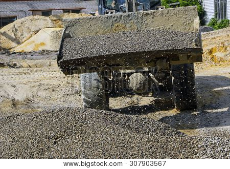 Tractor Collects Scoop With  Gravel. Excavator Extracts Sand And Gravel For  Concrete Mix.