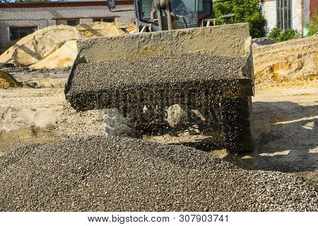 Tractor Collects Scoop With  Gravel. Excavator Extracts Sand And Gravel For  Concrete Mix.
