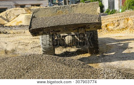 Tractor Collects Scoop With  Gravel. Excavator Extracts Sand And Gravel For  Concrete Mix.