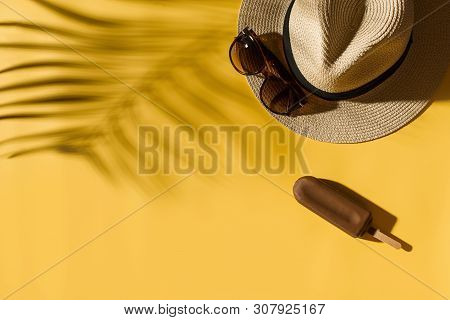 Hat Popsicle Ice Cream And Glasses On Bright Yellow Background With Tropical Leaf Shadow, Creative P