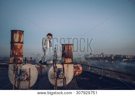 Urban Man With Hat Against The Background Of The City. Cool Guy. Wearing White Shirt And Jeans. Old 
