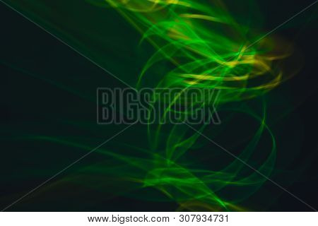 Yellow Neon And Green Neon Smoke Abstract. Neon Lines. Abstract Black Background. Neon Lights Textur