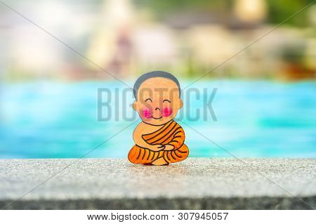 Buddhist Boy On Vacation Sitting In Lotus Position Happy Summer At The Edge Of The Pool. Center, Clo