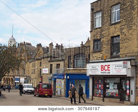 Bradford, West Yorkshire, United Kingdom - 19 June 2019: People Walking Past Old Buildings And Shops