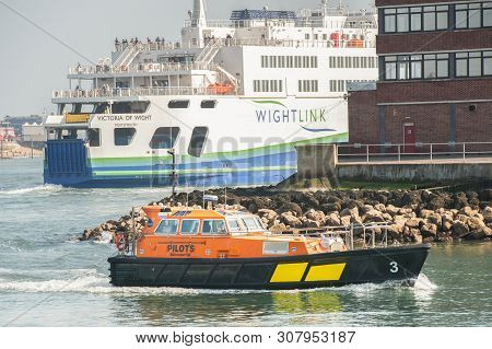 Portsmouth, Uk - April 1: Wightlink Ferry And Pilot Tug In The Historic Naval Dockyard Port Of Ports
