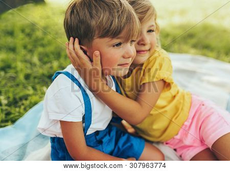 Candid Image Of Smiling Two Children Playing And Enjoying The Sumemrtime On The Blanket Outdoors. Si